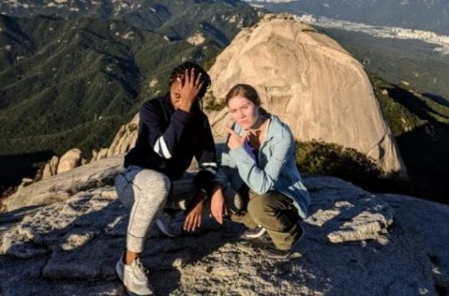 Thyra and her friend Ashley posing at the peak of Bukhansan Mountain.