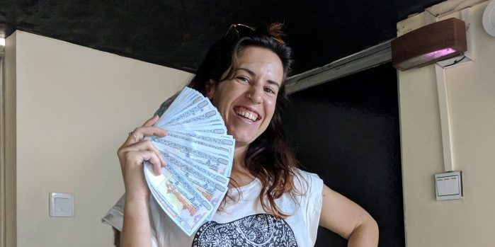 Andrea holding a huge wad of Burmese money.